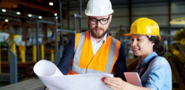 workers-discussing-expansion-hardhats